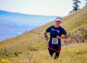 Woman enjoying a trail marathon in the vibrant hills of Wenatchee, Washington.